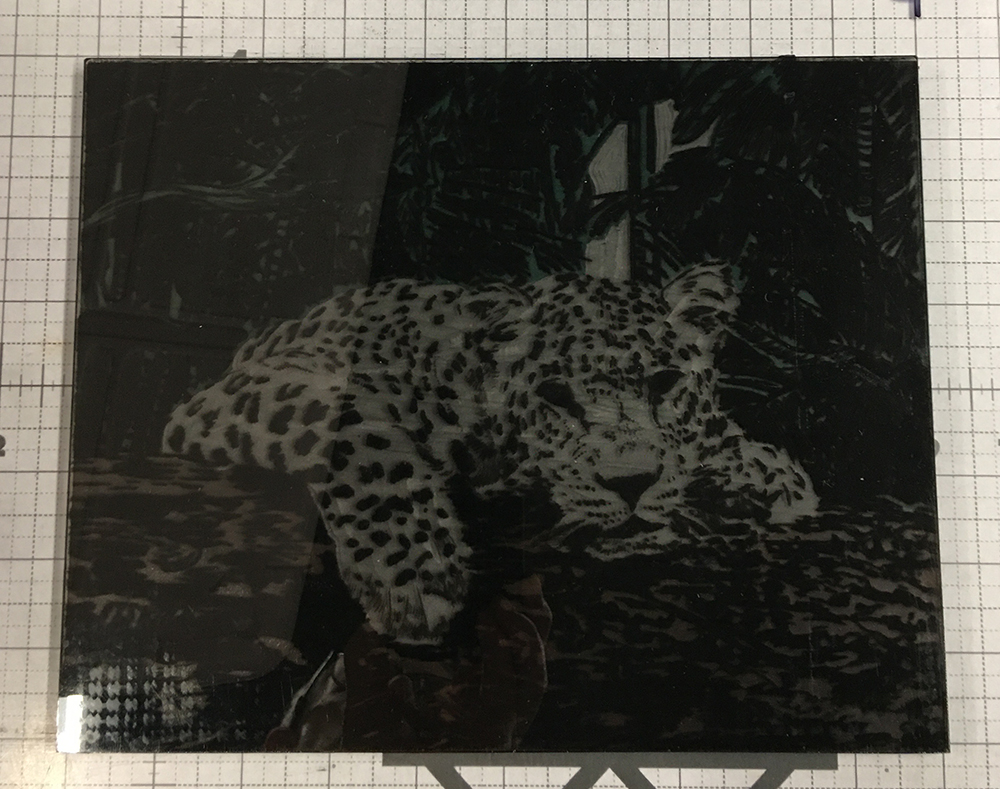 Leopard etched plate onto of the leopard inked linoleum block